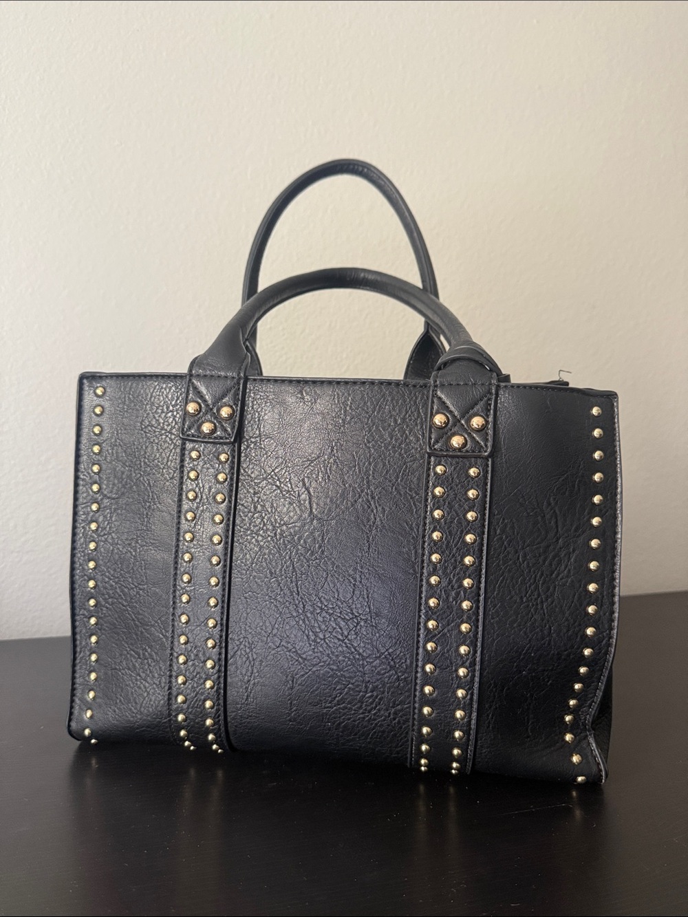Black studded leather handbag with concealed carry holster